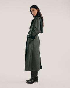 Black and olive green classic trench coat with wide lapels, tortoise shell buttons, welt pockets and hidden detachable belt.