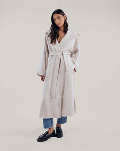 Oversized cream cashmere wool coat with shawl collar that leads to an oversized hood and detachable belt on the waist.