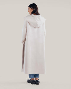 Oversized cream cashmere wool coat with shawl collar that leads to an oversized hood and detachable belt on the waist.