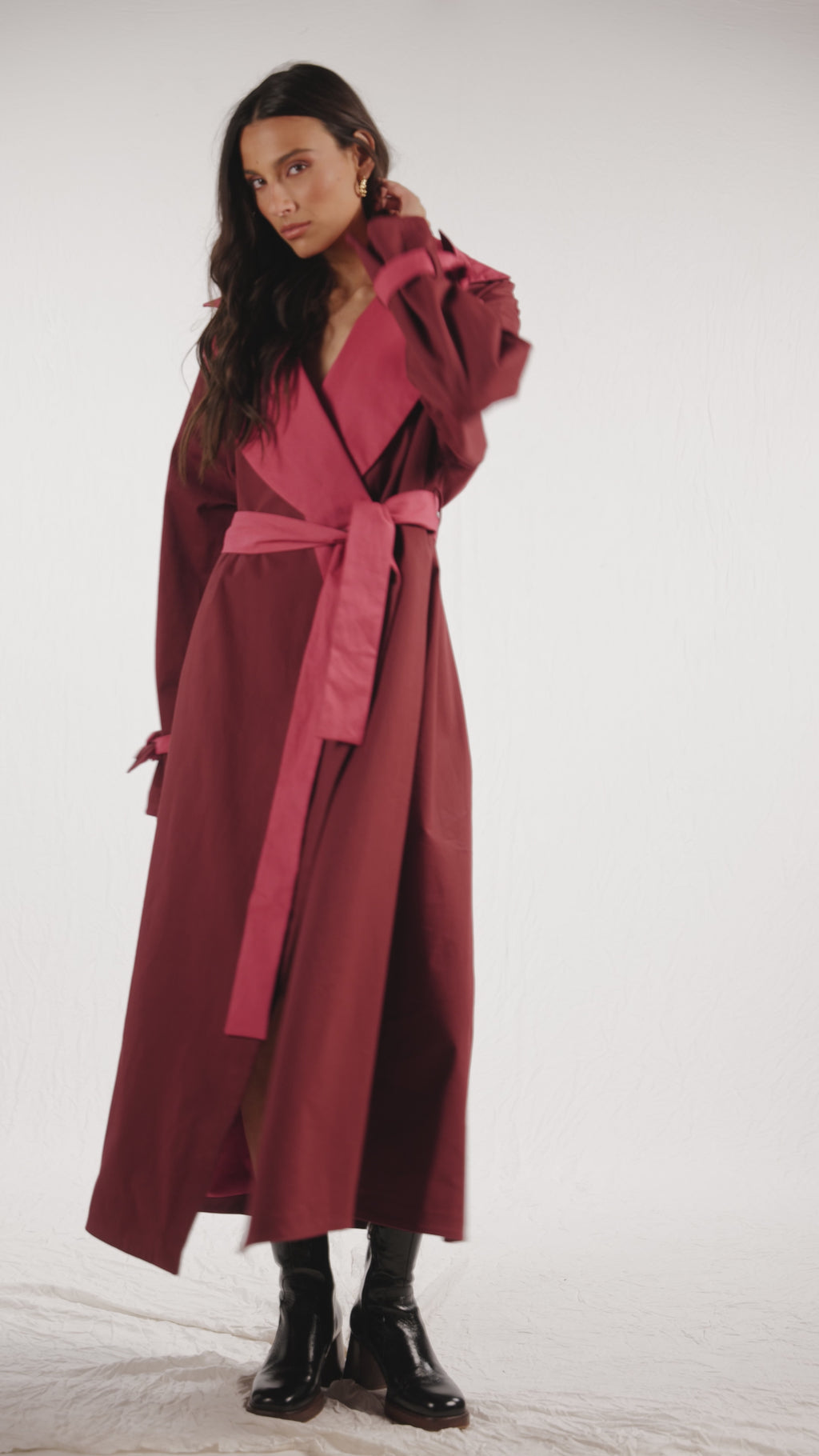 Reversible red or pink coat with detachable belt, front welt pockets and belted cuffs.