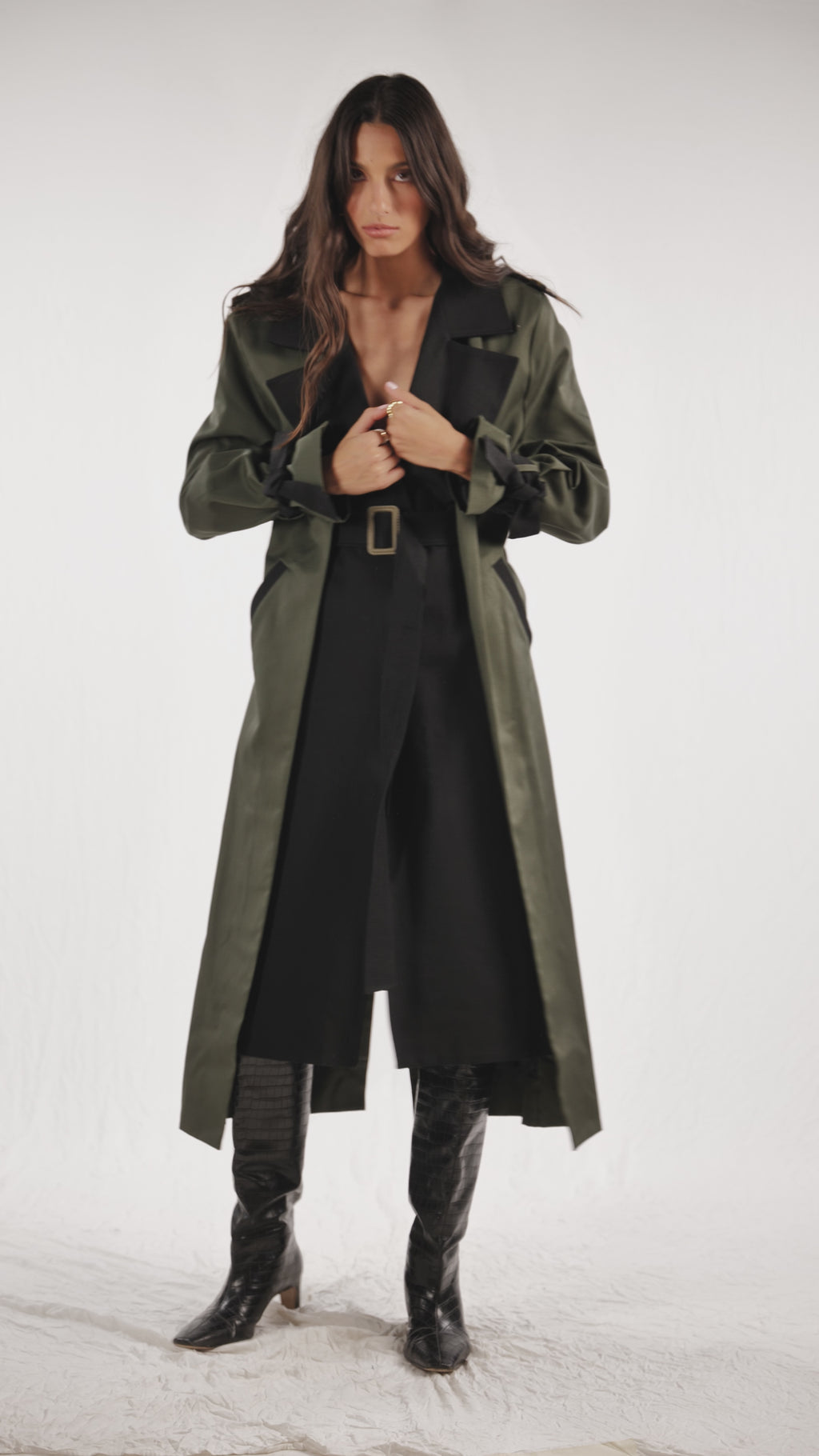 Black and olive green classic trench coat with wide lapels, tortoise shell buttons, welt pockets and hidden detachable belt