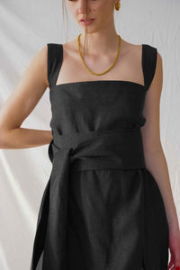 Black midi dress with square neckline.