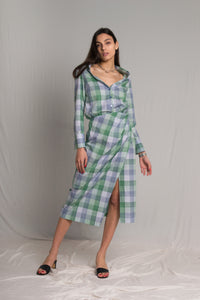 Plaid shirt dress with an elasticated waist and a side button closure a tight-high slit and an open V-neckline