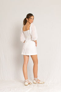 Short white mini dress with peasant sleeves and dainty embossing