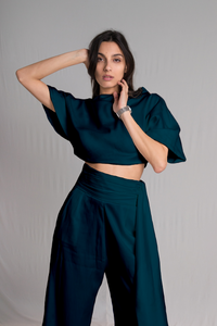 Teal cropped top with a relaxed cowl neckline and high-waist pants with a hidden zipper pockets and a hand-ruched waistband